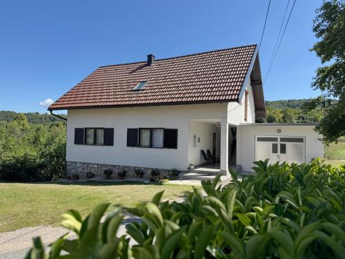 a white house with a red roof at Cherry Hill Loft in Plitvička Jezera