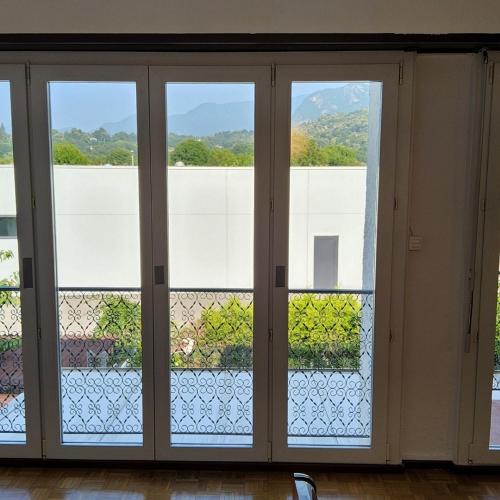 a door with three glass windows in a room at ruhiges Haus am See in Agno in Agno
