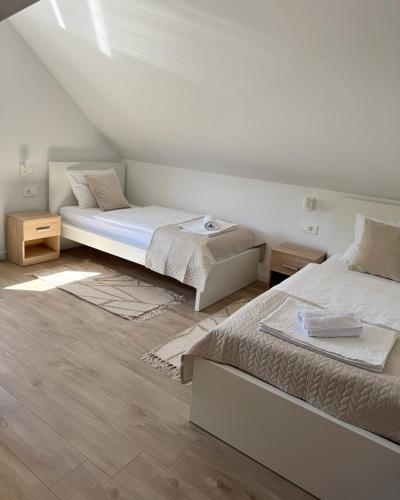 a bedroom with two beds and a sloped ceiling at Cherry Hill Loft in Plitvička Jezera