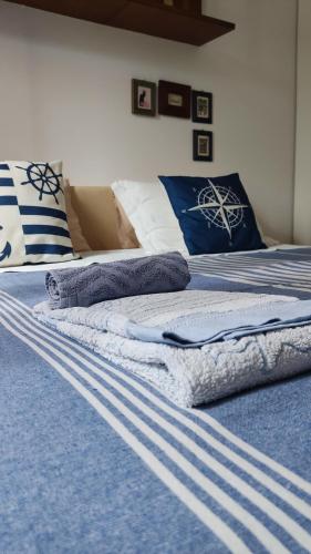 two beds with blue and white blankets and pillows at A casa di Milena in Porto Recanati