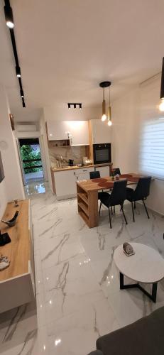 a large living room with a table and a kitchen at Apartman Marija in Kladovo