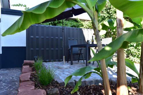 a patio with a table and a chair at Ferienwohnung Südwestpfälzer Ruheoase in Busenberg
