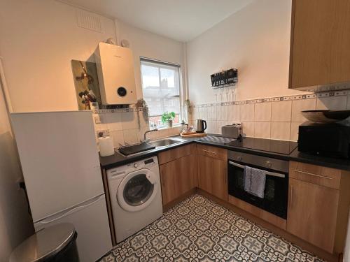 a kitchen with a washing machine and a washer at Chester City Centre Apartments in Chester