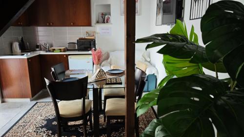 a dining room with a table and chairs and a kitchen at Kozakos Luxury House in Pano Lefkara