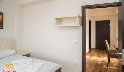 a room with a bed and a table and a dining room at Lotos - stan 421 L2 in Dobra Voda