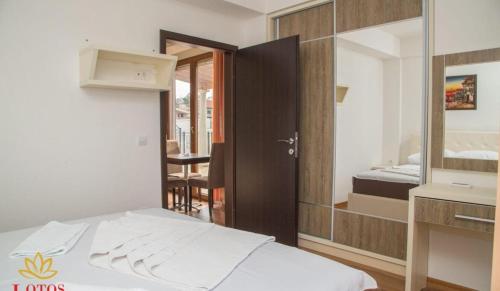 a hotel room with a bed and a mirror at Lotos - stan 421 L2 in Dobra Voda