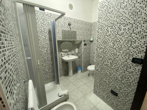 a bathroom with a shower and a toilet and a sink at Memole Inn Sanremo in Sanremo