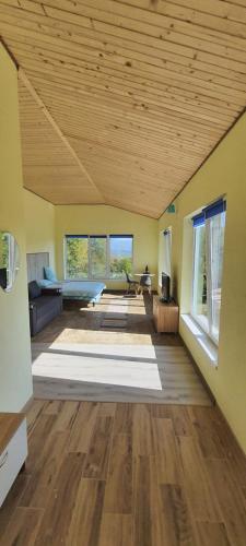 a large living room with a wooden ceiling at LeGora in Pryborzhavsʼke