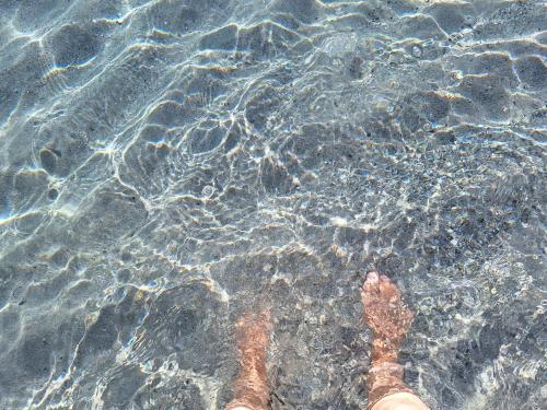 a persons feet standing in the water at Da Bonny in Siniscola
