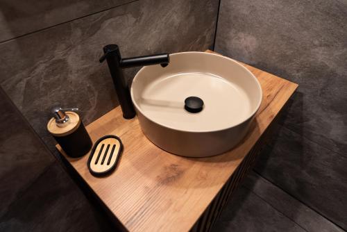 a bathroom sink on a wooden counter with a brush at Ośrodek Wypoczynkowy Bernadetta in Murzasichle