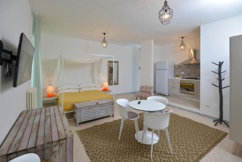 a bedroom with a bed and a table and chairs at Al Quarantacinque in Maglie