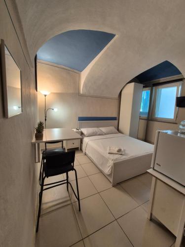 a bedroom with a bed and a table and a chair at Alice Apartments in Crescentino