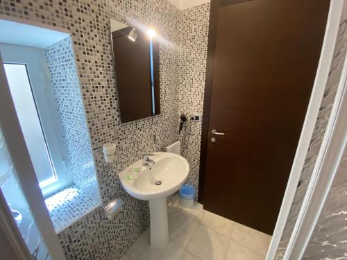a bathroom with a sink and a mirror at Memole Inn Sanremo in Sanremo