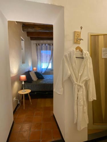 a robe is hanging in a room with a bed at La Casa Del Cacao in Lecchiore