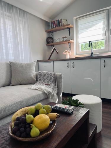 a living room with a bowl of fruit on a table at Stan Maric in Široki Brijeg