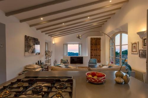 a kitchen with a stove and a living room at Mallorca Villa with Private Pool, Villa 1009 in Deia