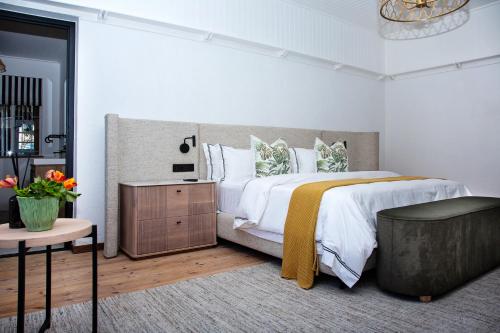 a bedroom with a large bed and a table at Paarl Hideaway in Paarl