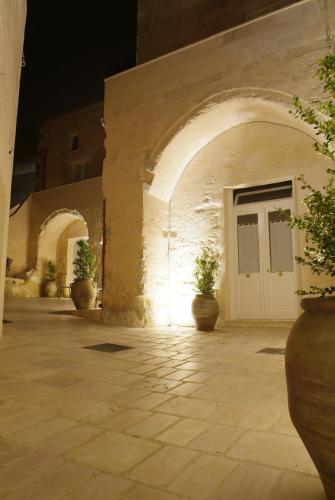 an entrance to a building with potted plants and a door at Caveoso Hotel in Matera