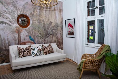 a living room with a couch and a wall mural at Paarl Hideaway in Paarl