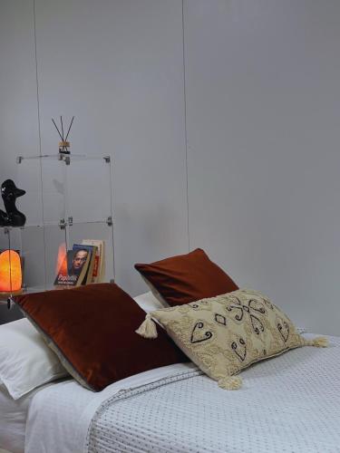 a bedroom with a bed with two pillows on it at Cheap Quiet Double Room in Park Royal with off-site Gym Access to Showers in London