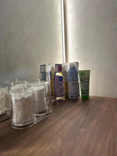 a group of bottles ofodorizers and glasses on a table at Primavera apartments Banja Koviljaca in Banja Koviljača