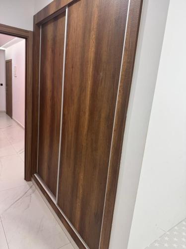 a wooden door on a wall in a room at Iquama atawhid I in Nador
