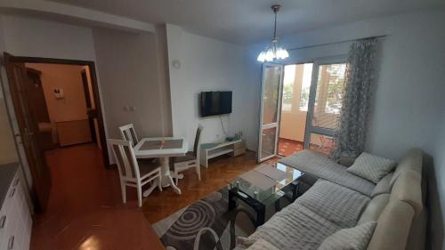 a living room with a couch and a table at Family Comfort Apartment in Bar