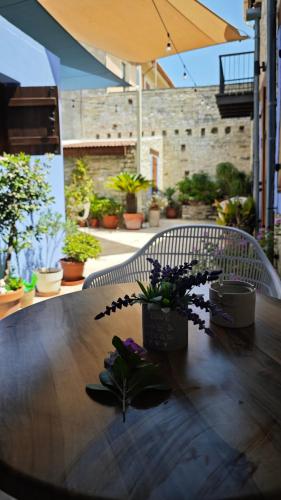 a wooden table with potted plants on top of it at Kozakos Luxury House in Pano Lefkara