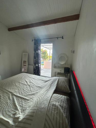 a bedroom with a bed in the corner of a room at Calm#Child friendly#Home#Beach#Airport in Saint-Laurent-du-Var