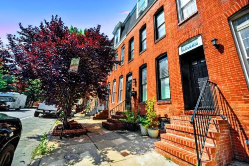 a red brick building with a tree in front of it at Federal Hill & Inner Harbor Lux Retreat Sleeps 6 in Baltimore