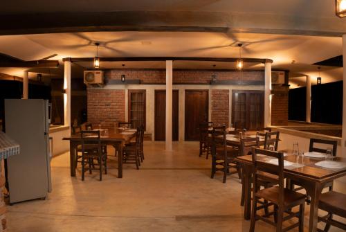 a dining room with wooden tables and chairs at Wild Edge Panama - Kumana Safari Lodge in Panama