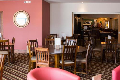 a dining room with a table and chairs at Blue Bay View - One Bed Apartment @ The Bay, Filey in Reighton
