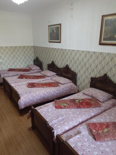 a group of four beds in a room at Guest House Fazisi in Kutaisi