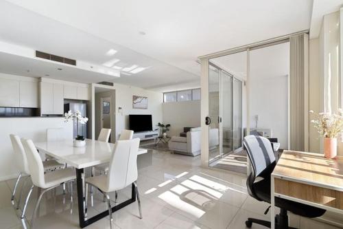 a dining room and living room with a table and chairs at 81M City View Abnb-Style 3BR Near Mascot Station with 2 FPKG in Sydney