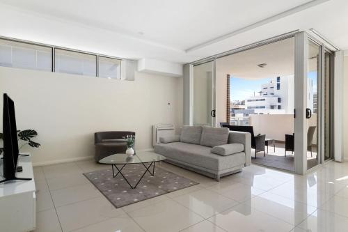 a living room with a couch and a table at 81M City View Abnb-Style 3BR Near Mascot Station with 2 FPKG in Sydney