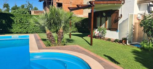 a swimming pool in a yard next to a house at L'Oasi Bed and Breakfast di Franco e Paola in San Martino Canavese