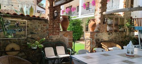 a patio with a table and chairs in a building at L'Oasi Bed and Breakfast di Franco e Paola in San Martino Canavese