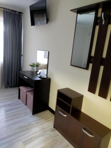 a bathroom with a black vanity and a mirror at Pensiunea Casa Vio in Cinciş
