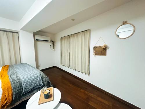 a bedroom with a bed and a table at sakura 206 in Tokyo