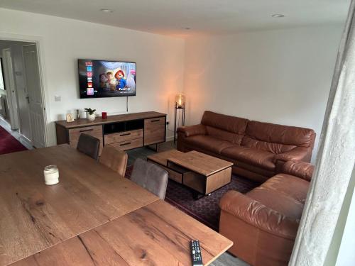 a living room with a couch and a table at Luxe retreat Unwind in Elegant Style in Hatch End