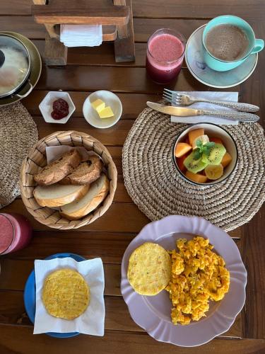 a wooden table topped with plates of food and snacks at Hotel Boutique Casa Encanto Barichara in Barichara