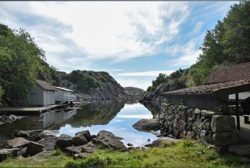 a river with buildings next to a body of water at Separate floor in a private house with a private entrance in Egersund