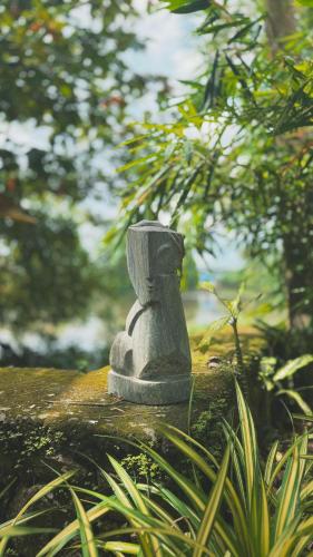 a stone statue sitting on top of a fence at Sunsets and Palm Trees in Alleppey