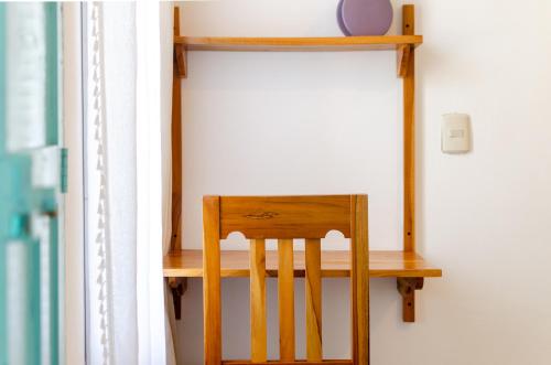 a wooden chair sitting on a shelf in a room at Casa Ramona in Flores