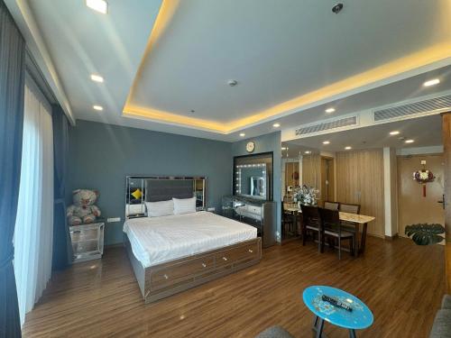 a bedroom with a large bed and a dining room at FLC Sea Tower Quy Nhơn Seaview Apartment in Quy Nhon