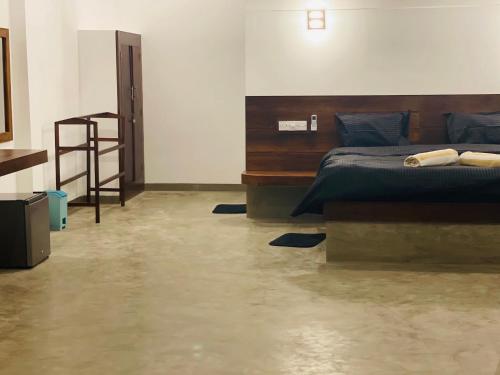 a bedroom with a bed and a staircase in it at Ashansa Lagoon Resort in Tangalle