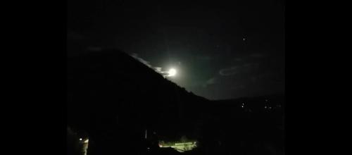 a light on top of a hill at night at Apartman Emma in Visoko
