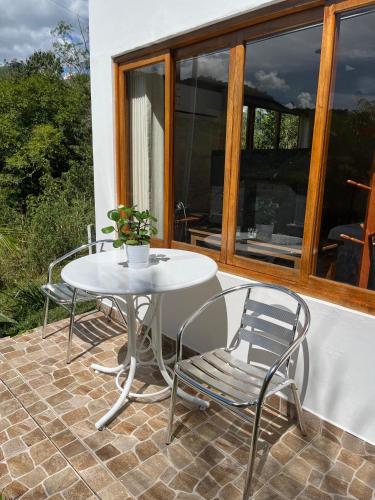 a white table and chairs on a patio at Albergue Turístico Gstir in Pozuzo