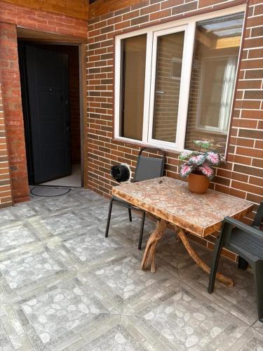 a patio with a table and chairs and a window at Old Tbilisi Apartments in Tbilisi City
