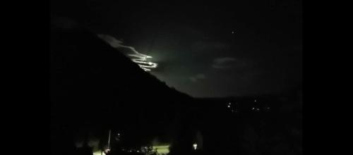 a lightning storm in the sky at night at Apartman Emma in Visoko